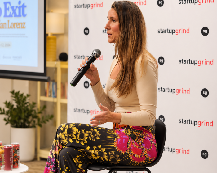 Jillian Lorenz speaking on stage with a microphone